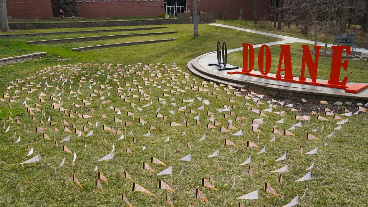 Nearly 700 orange ONE DOANE pennants are displayed in front of the large GO DOANE letters in Cassel Theatre, representing the success of this year’s One Day. One Doane.