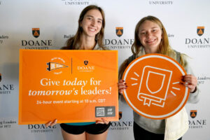 Students Julie Sparks and Jessica O’Day pose for a photo during the student celebration of “One Day. One Doane.” hosted before the blizzard on Tuesday, March 18.